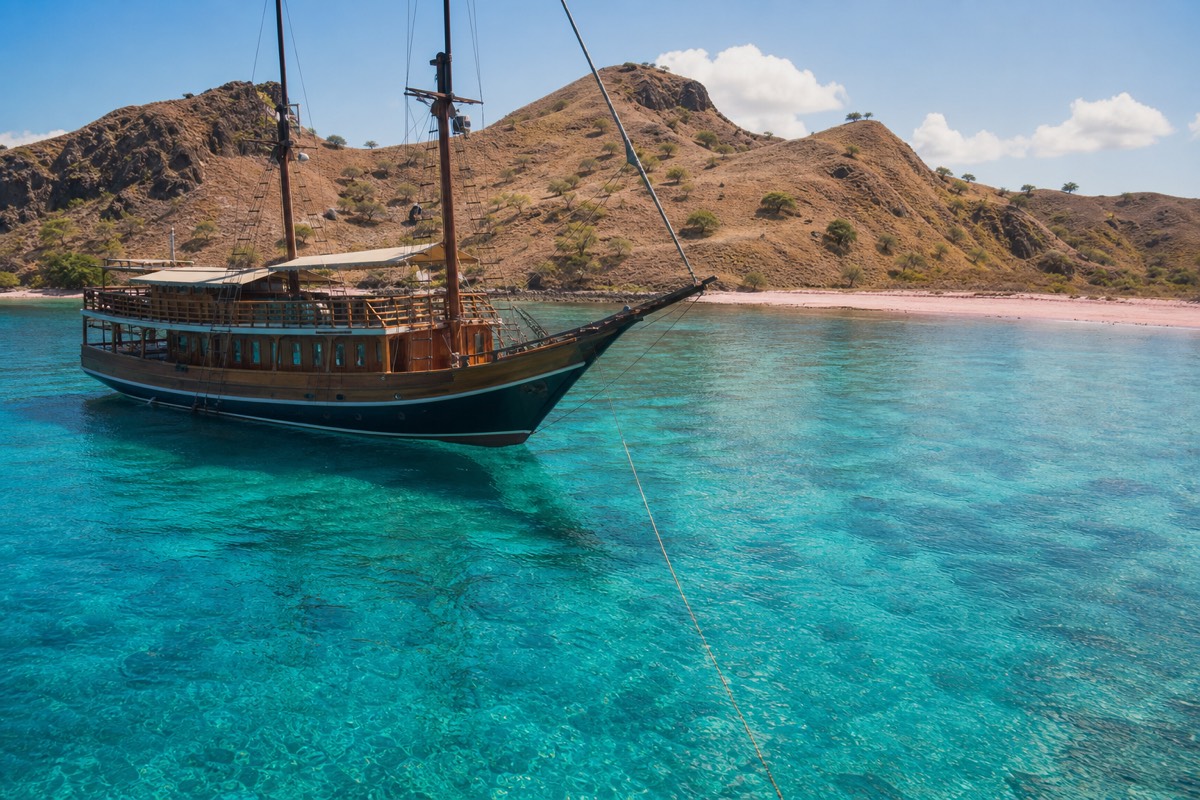 A Phinisi liveaboard anchored near Pink Beach in Komodo National Park